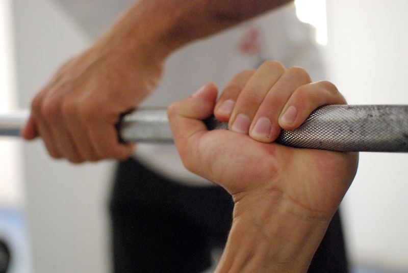 person holding barbell bar