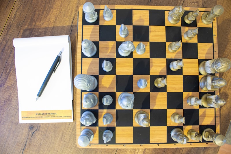 A chess board with a pen on top of it