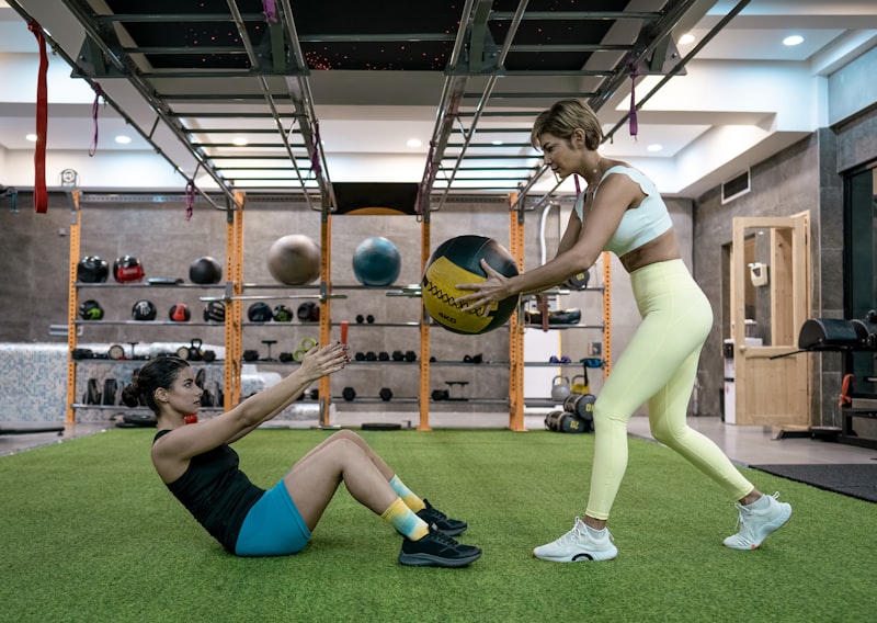 A couple of people that are playing with a ball