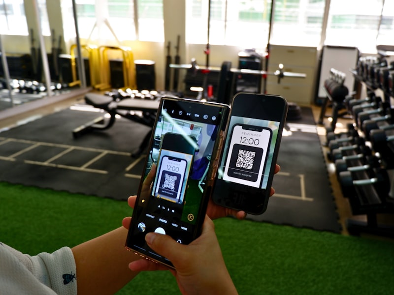 a person holding two cell phones in their hands