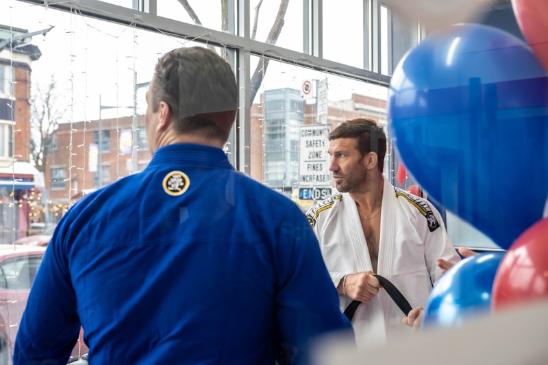 A group of men standing next to each other in front of a window