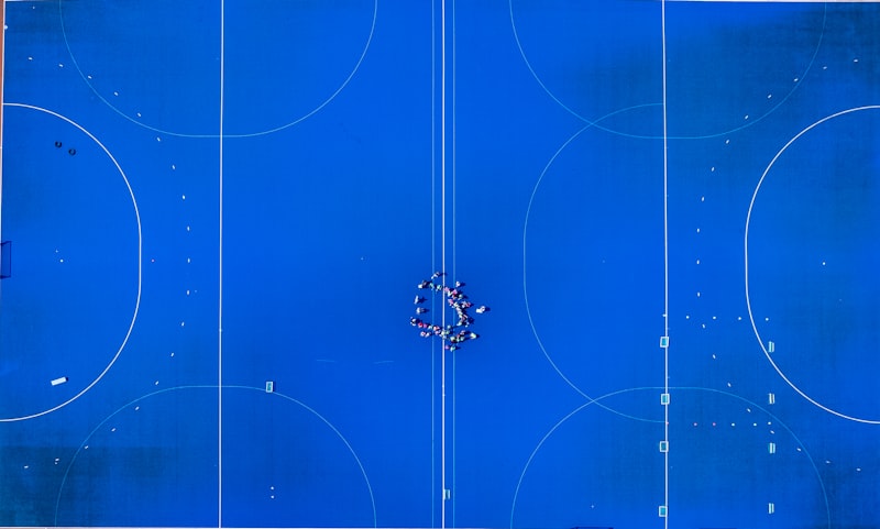 A blue basketball court with a bunch of circles on it