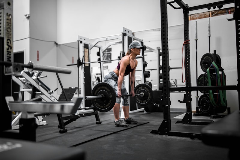 man in orange tank top and black shorts doing exercise
