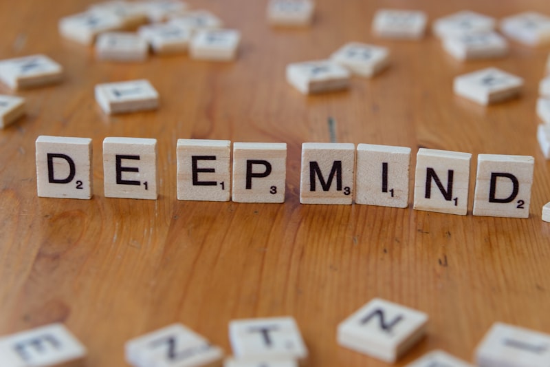 A wooden table topped with scrabble tiles spelling the word deep mind