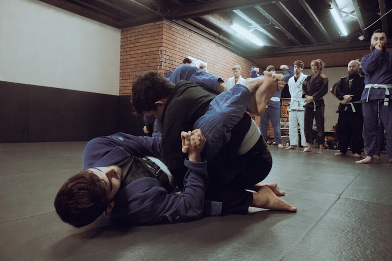 two people in a room with a group of people watching