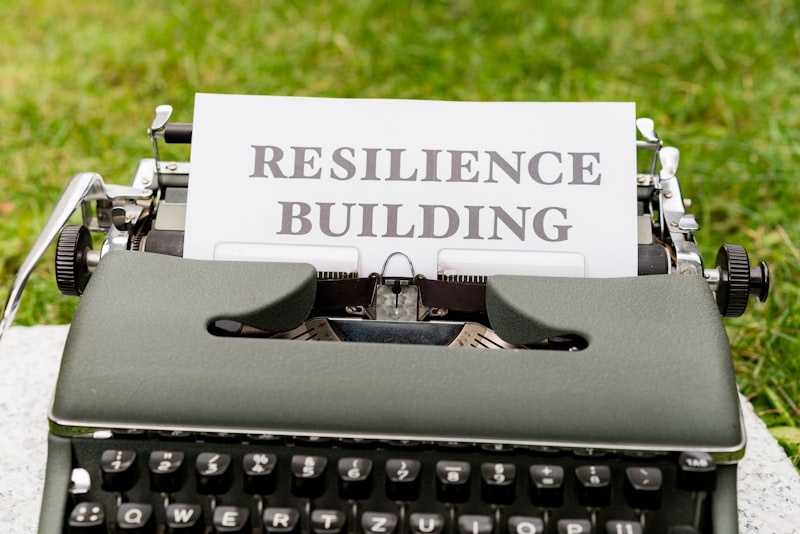a typewriter with a sign that reads resilince building