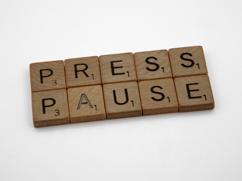a scrabble of words spelling press pause