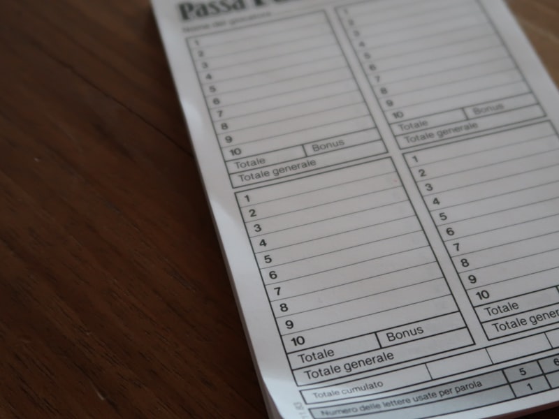 white paper document on brown wooden table