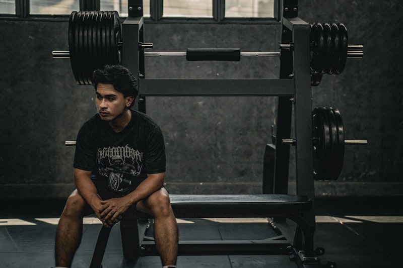 A man sitting on a bench in a gym