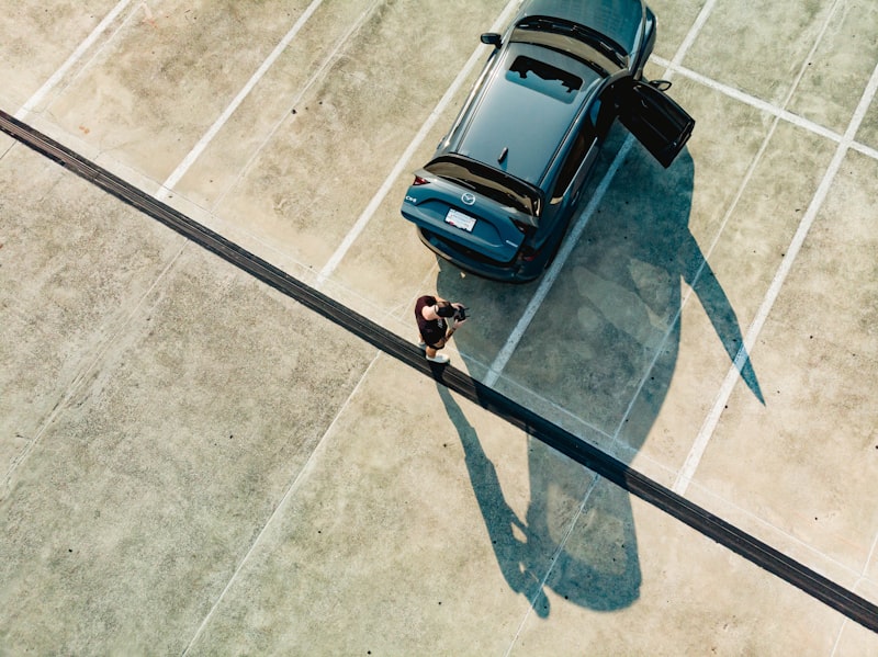 A blue car parked on a tennis court