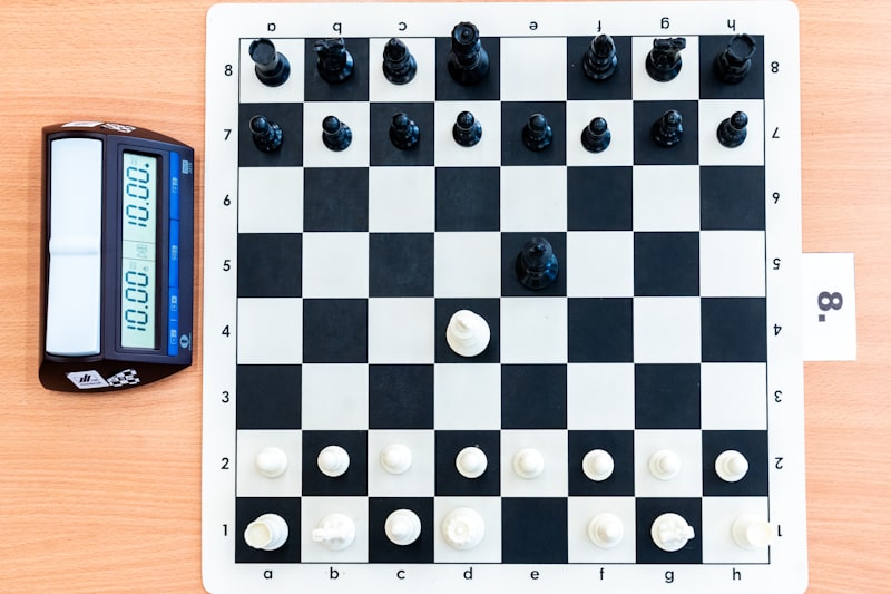 Chessboard with pieces and a digital clock