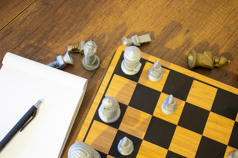 A chess board with a pen on top of it