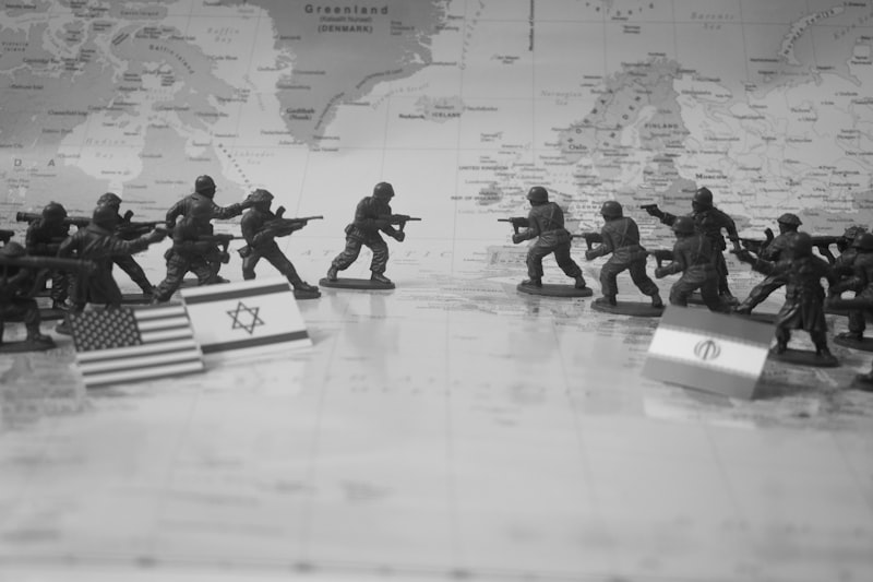 Toy soldiers in formation with flags on world map