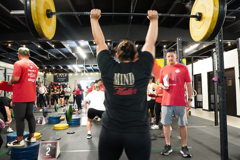 A woman lifts weights overhead during a competition.