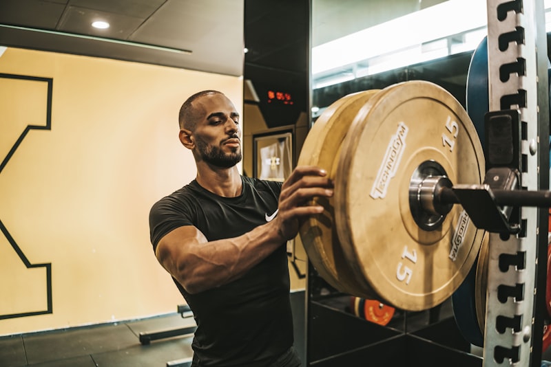 a man lifting a barbell in a gym