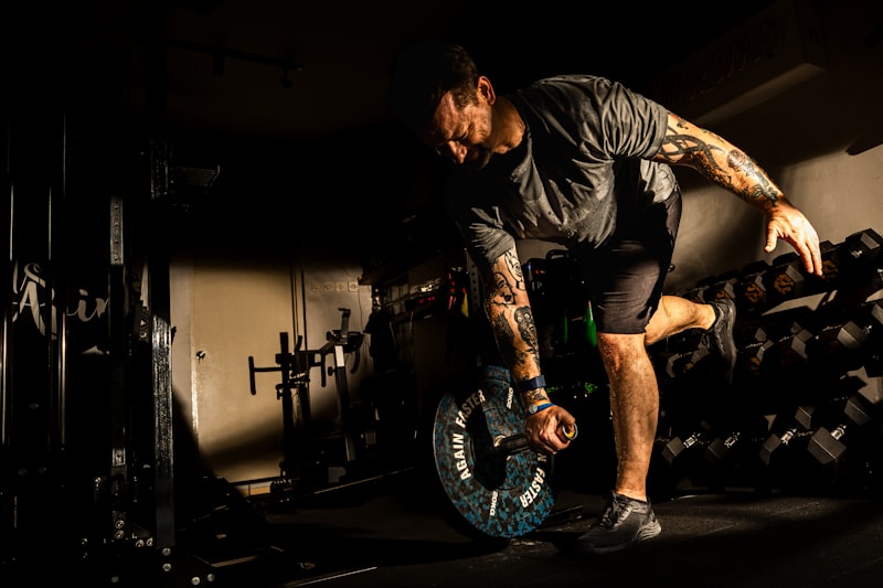 A man balances on one leg while working out.