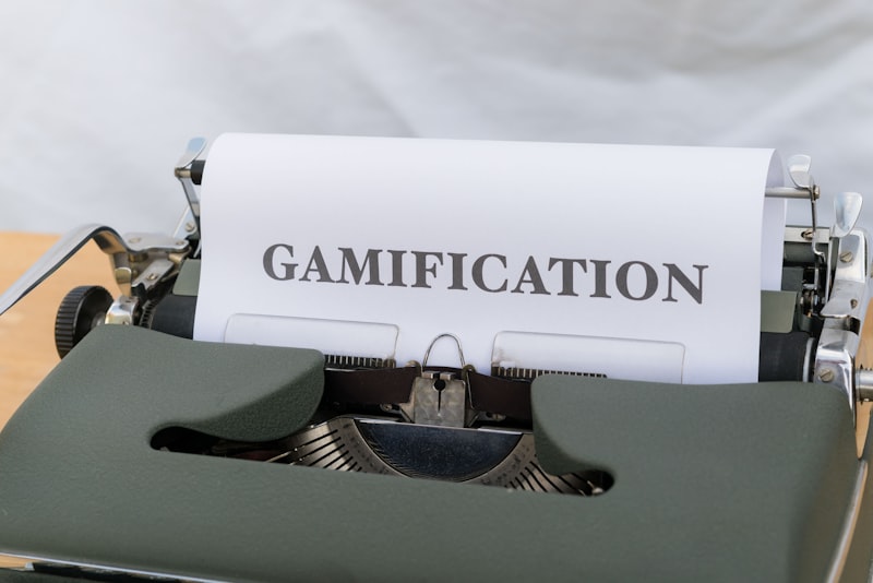 a close up of a typewriter with a paper that reads gamification