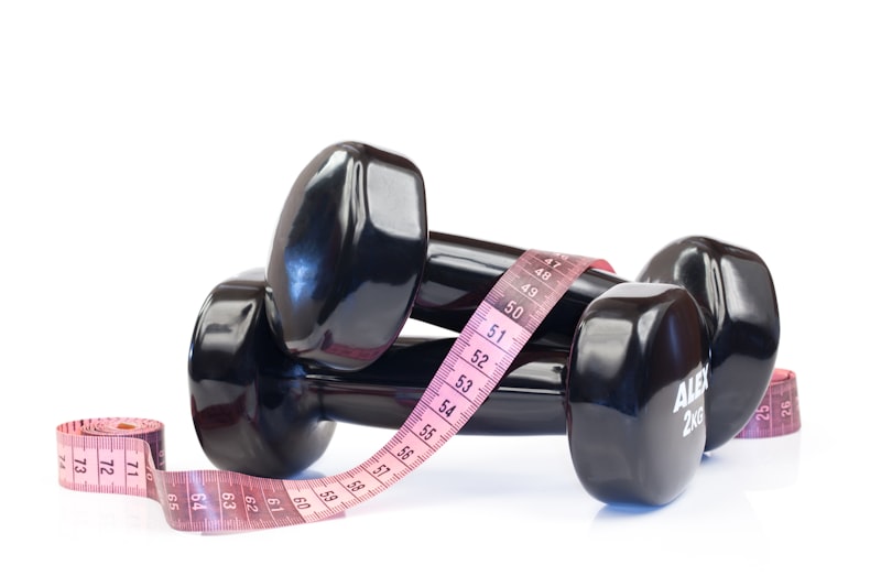 a pair of dumbs with a measuring tape around them