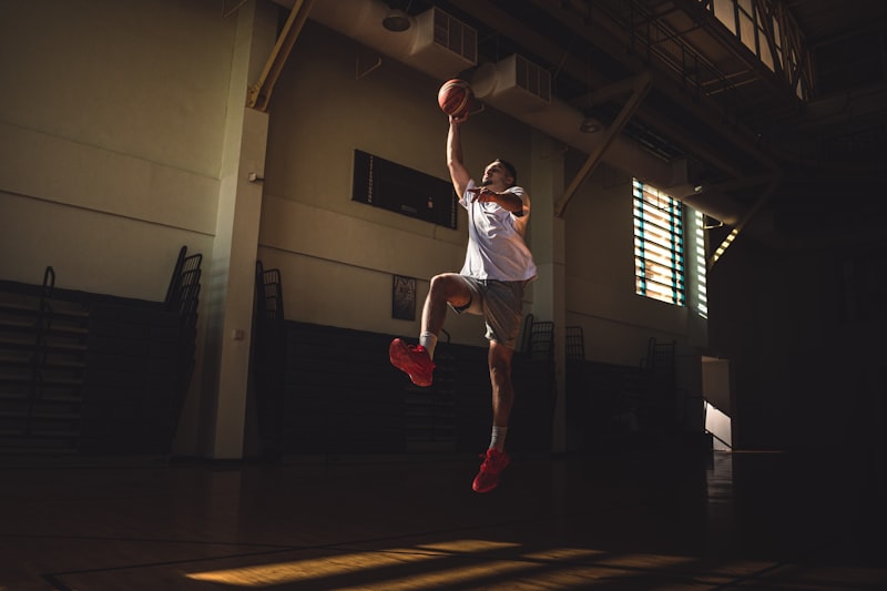 A person jumping in the air with a basketball